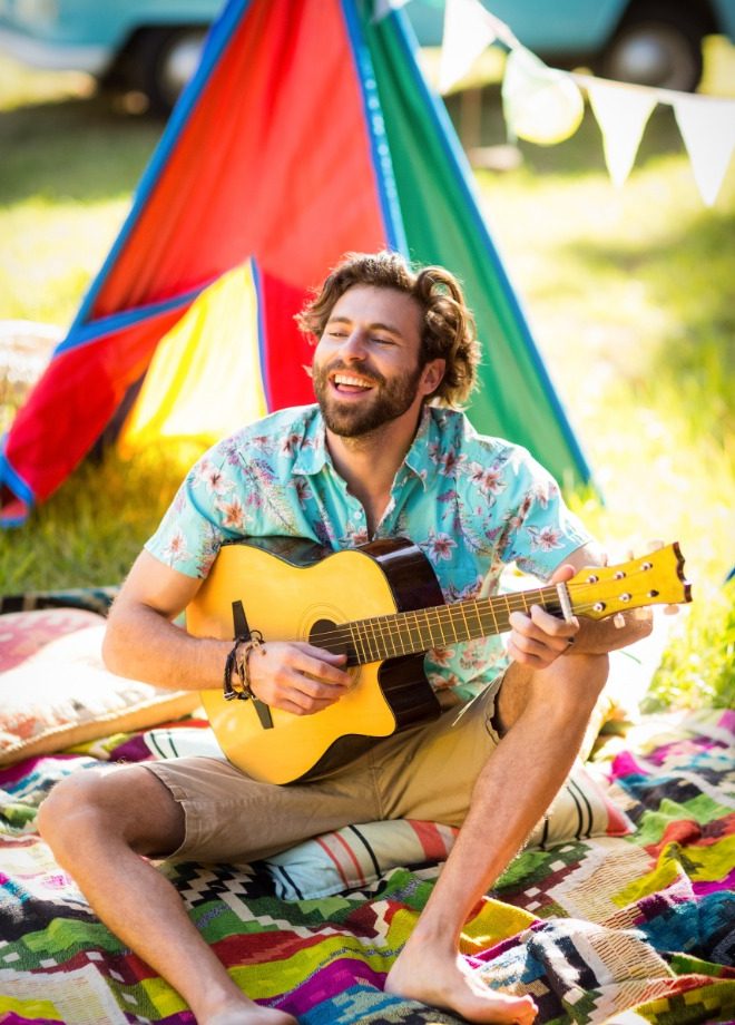 man-playing-guitar-at-campsite-CNVCZZA.jpg